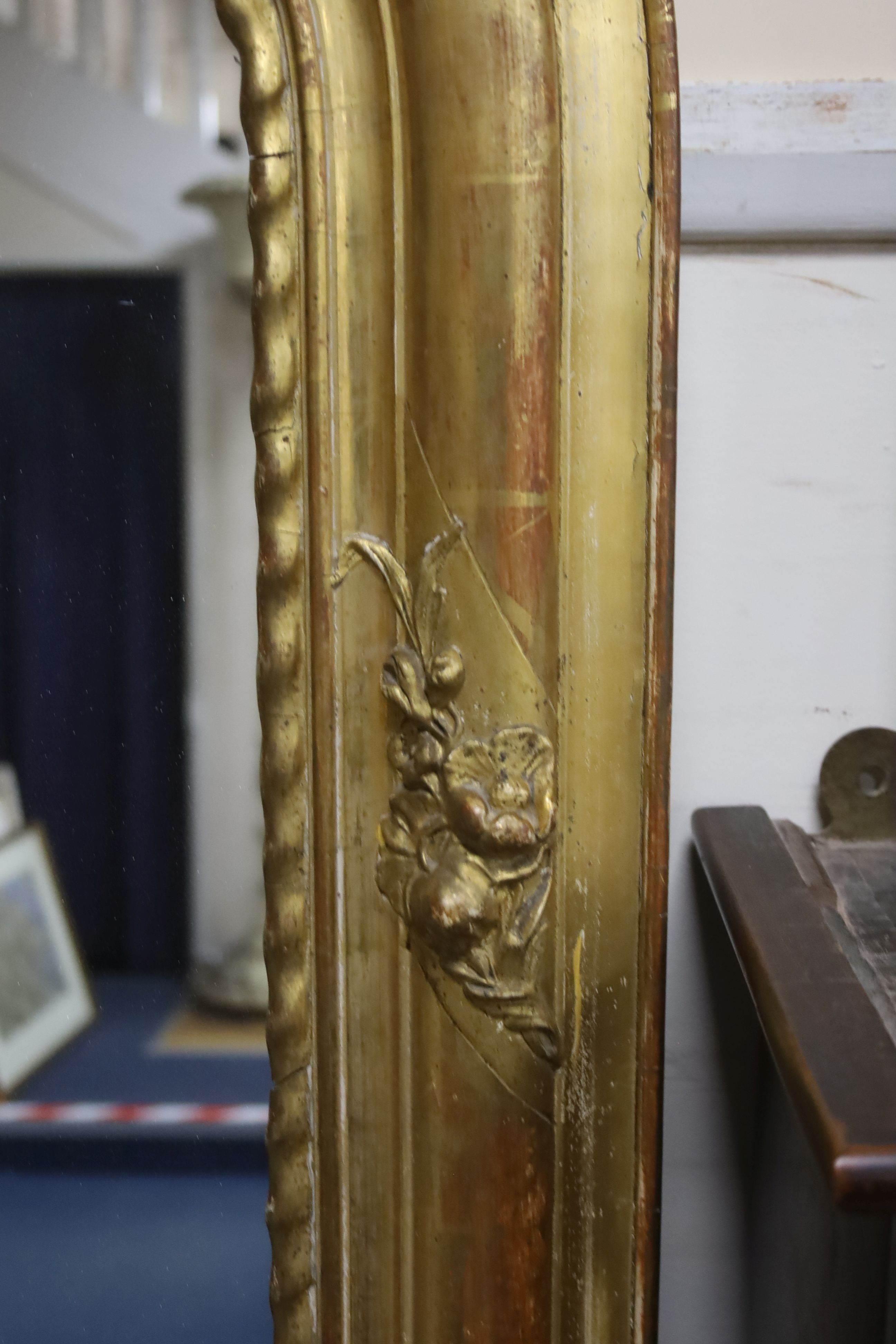 A 19th century French overmantel mirror, giltwood and gesso with channelled frame and scroll with cabochon crest detail, width 98cm, height 164cm